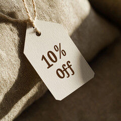 Discount tag showing 10% off on neutral fabric background  