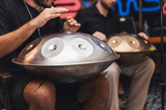 Musicians performing live with handpans at a concert