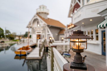 Beautiful tungsten lamp on a post at the US Life Saving Station on Cape Cod with a sailboat in the background