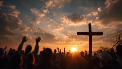 Faithful congregation raises hands in worship towards a wooden cross silhouetted against a breathtaking sunset sky with golden light beams