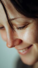A serene close up portrait of a smiling woman.