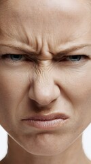 Extreme close up of a womans face scrunched in disgust.