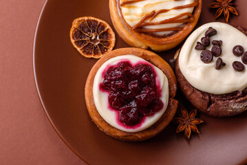 Cinnamon roll, a sweet bun with citrus, cherries, and chocolate, a Danish dessert with cream