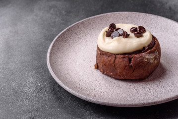Cinnamon roll, a sweet bun with citrus, cherries, and chocolate, a Danish dessert with cream