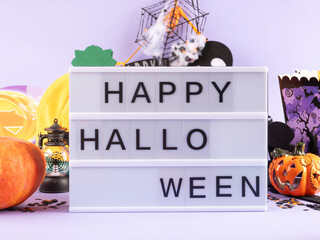 Happy halloween greetings on lightbox on purple background