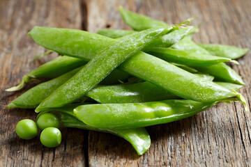 Fresh Pea Pods Scattered on a Wooden Table