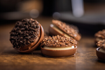 Sweet chocolate pralines. Chocolate candies on wooden table.