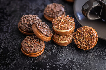 Sweet chocolate pralines. Chocolate candies on black table.