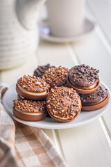 Sweet chocolate pralines. Chocolate candies on plate on white table.