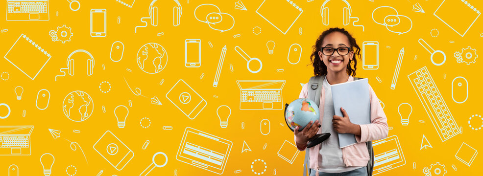 A cheerful child stands proudly holding a globe and a stack of books, showcasing excitement for learning.