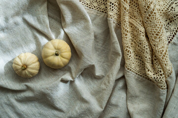 Colorful decorative pumpkins on linen fabric, top view. Autumn aesthetic	