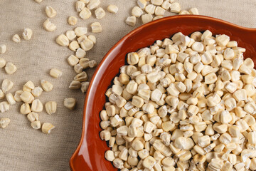Dried corn in different textures and sizes, placed on handmade plates.