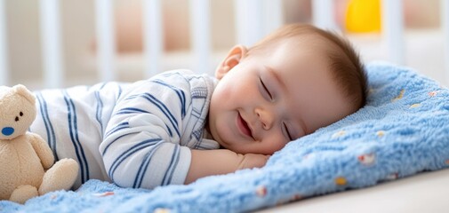 Infant resting peacefully in crib next to teddy bear, wearing striped pajamas and smiling on light blue patterned blanket