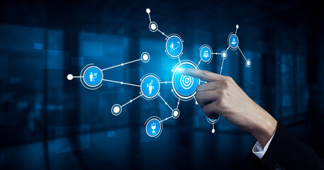 Fototapeta premium A hand interacts with a digital touchscreen, engaging with a network of icons in a blue background, symbolizing modern technology and digital connection. Tessel