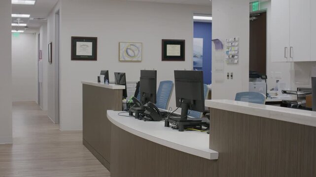 Plate shot of a well-organized nurse station with wood flooring and minimalist decor.