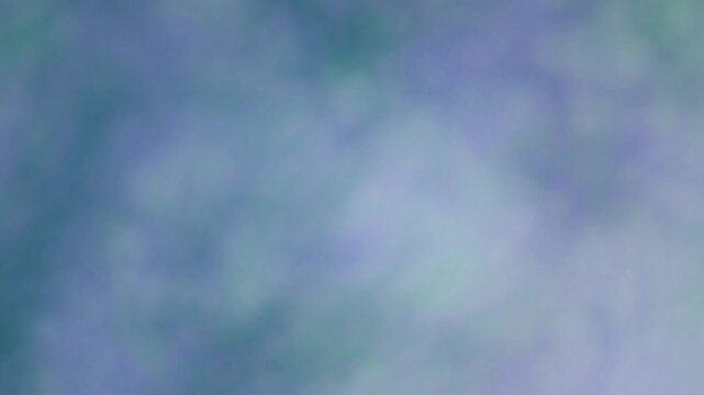 Green blue aqua clouds of swirling patterned sky of teal and turquoise shades with slithers of purple cloudy fog haze textured background animation 4K