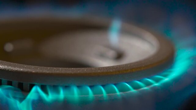 Flame of a Kitchen Gas Burner. The chamber slowly rotates around the burning gas burner. The flame starts to twitch and goes out behold an intense gust of wind