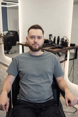Portrait of customer man after a haircut in style barbershop. Bearded Man client visit gentleman grooming beauty salon for hairstyle care. Male skin care and beard style concept. 