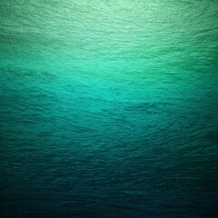 An abstract view of the ocean, with varying shades of teal and blue creating a sense of depth and tranquility. The textures of water are gentle, and the colors evoke a feeling of serenity and calm.