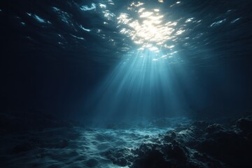Fototapeta premium Underwater ocean blue abyss illuminated by rays of sunlight filtering through the surface, showcasing serene aquatic landscape