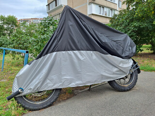 Cover on motorcycle parked near a house © Harmony Video Pro