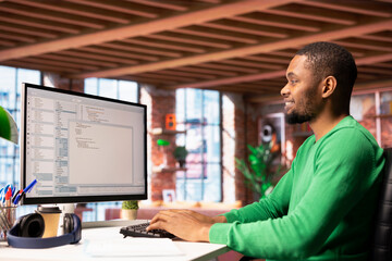 Happy software developer at PC coding, creating software, implementing algorithms. Cheerful IT...