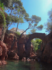 Old Stone Bridge over Rocky Coastline with Clear Water