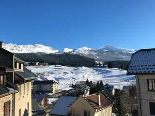 Snowy Alpine Village with Mountain Ski Slopes