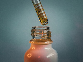Close-up of a glass dropper dispensing amber oil into a white bottle with a soft gradient background, representing natural beauty care, skincare, wellness, and organic cosmetics.