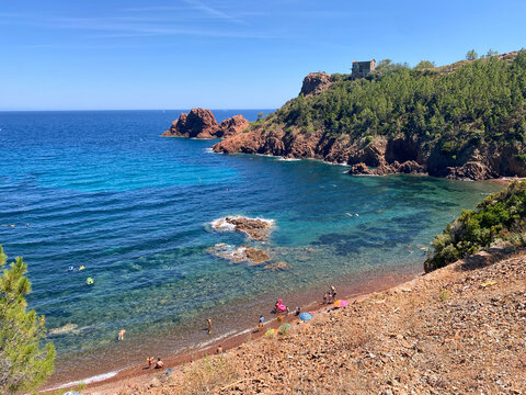 Scenic Beach with Rocky Coastline and Swimmers