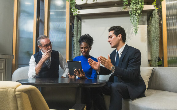 business meeting discussion among people seat around table modern office tablet on table convey collaboration communication relax working environment making suitable content related team office life.