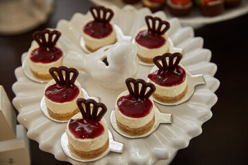 Mini cheesecakes com calda de frutas vermelhas e coroa de chocolate