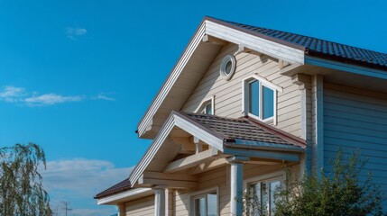 Gable roof circular vent for air circulation on a house under a clear blue sky