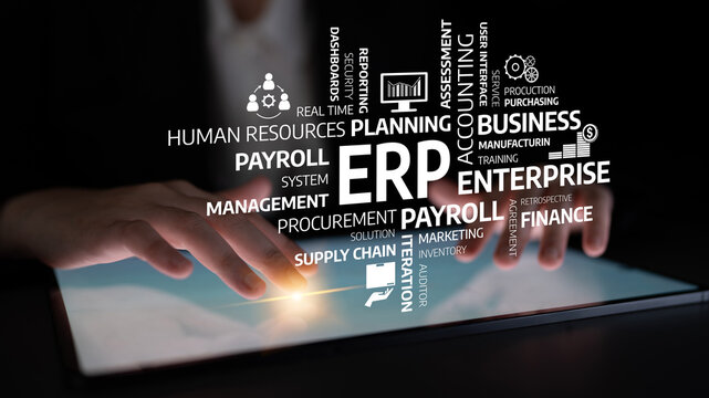 A close-up view of hands interacting with a tablet screen displaying various ERP-related terms, symbolizing modern business functions and digital management. Tessel - Powered by Adobe