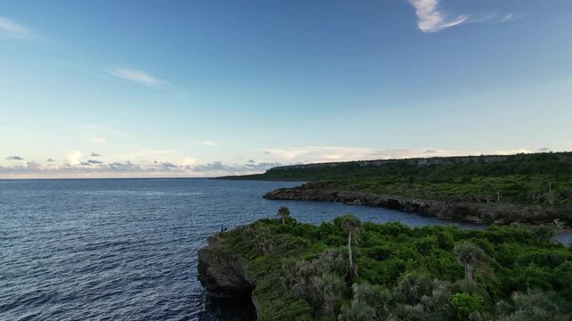 Drone capture of Boca de Yuma&rsquo;s shoreline and waves with soft evening light and seaside trees &mdash; great for cinematic B-roll, nature films or relaxed travel visuals