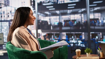 Confident businesswoman in a corporate meeting sharing ideas with investors group, focusing on enterprise growth. CEO in dynamic work environment shaping business strategy, female boss. Camera B.