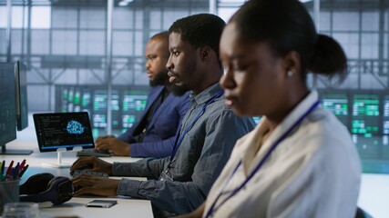 System administrators in data center implementing AI predictive maintenance systems. Teamworking...