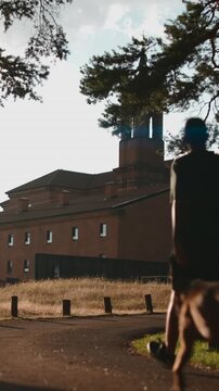 Man walking a dog near the san juan monastery in the gardens of soestdijk palace, baarn, netherlands