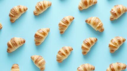 Delicious Golden Croissants Patterned on a Light Blue Background