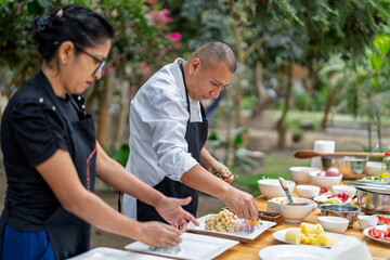 Chefs preparing fresh peruvian ceviche outdoors