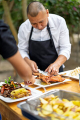 Chef plating traditional peruvian guinea pig dish