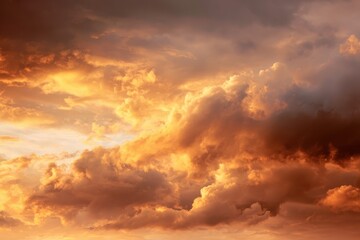Fototapeta premium Majestic display of golden clouds in a vibrant sunset sky creates a striking abstract background filled with warmth and tranquility