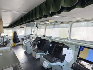 navigation bridge of the cargo ship. nautical equipment and charts 24