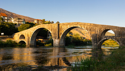 Fototapeta premium View of a stone arched bridge over a river. Peroviс bridge or Arslanagiс bridge in Bosnia and Herzegovina