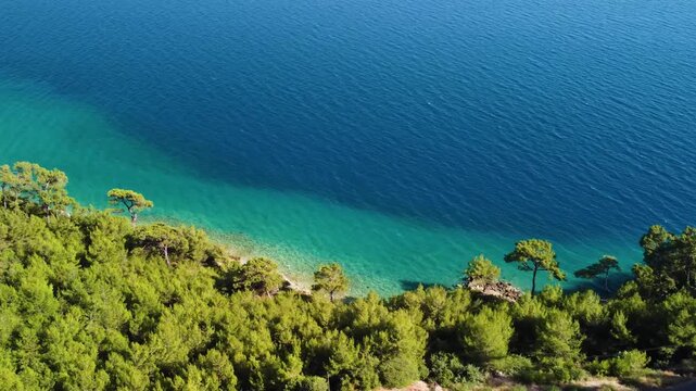 aerial perspective showcasing the historical ruins of Knidos Antik Kenti nestled along the stunning turquoise coastline of the Aegean Sea in Dat&ccedil;a, Turkey.