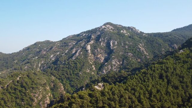 footage showcasing the vibrant, lush green mountains and serene natural beauty surrounding Turunc, a picturesque village on Turkey's stunning Aegean coast. Ideal for travel, nature, and documentary pr