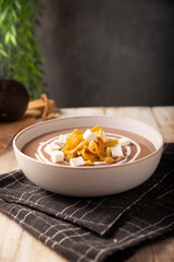 Creamy bean soup. In Mexico known as Crema de Frijoles, nutritious homemade food recipe, commonly accompanied with cheese, cream, avocado and corn tortilla cut into strips and fried.