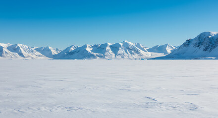 Fototapeta premium Vast Arctic Winter Landscape: Snow-Covered Mountains and Icy Plains under a Clear Blue Sky
