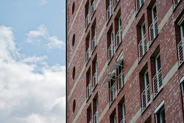 Fototapeta premium Brick building under construction with tiny door balconies