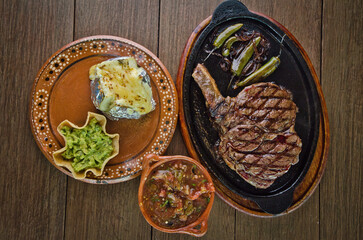 Sizzling Grilled Cowboy Steak Dinner with a Loaded Baked Potato and Salsa